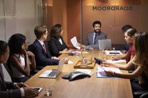 Corporate business people at an evening boardroom meeting
